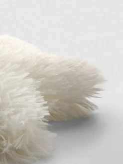 Sternförmiges Kissen im Pompon-Stil